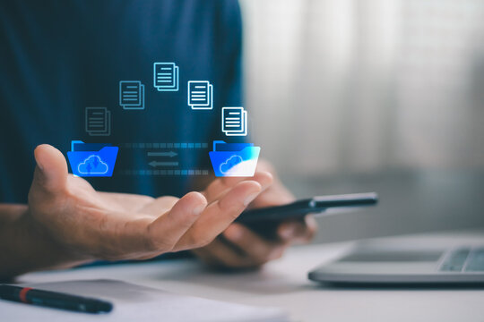 Cloud file transfer concept with digital folder and document icons above a person hand and smartphone, secure data synchronization, online backup, cloud storage, document sharing and digital workflow.