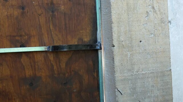 Hand removing a plastic wall plug anchor from wall