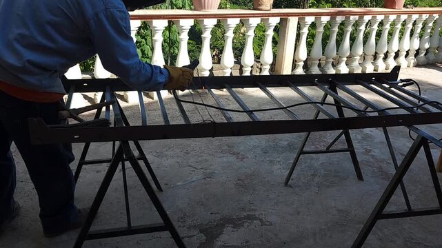 Industrial welding process on a heavy iron frame structure