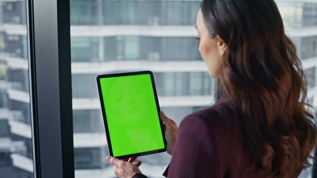 Office worker looking mockup tablet reading email at cityscape workplace closeup