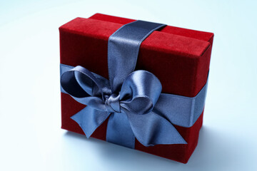 Fototapeta premium Beautiful velvet gift box on light blue background, closeup