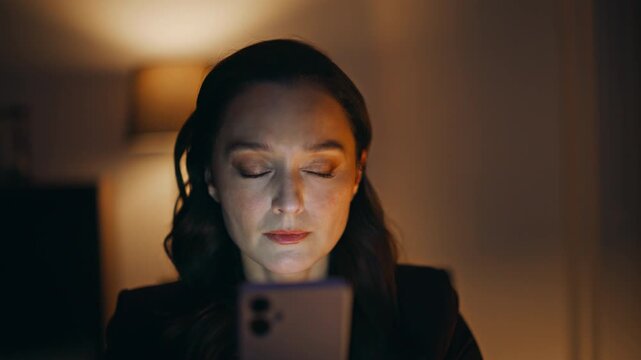 Night worker scrolling news feed cellphone sitting corporate workplace closeup