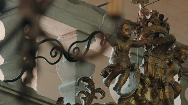 Golden carved cherubs and scrollwork on ornate baroque church woodwork in Portugal