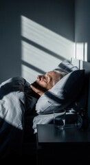 Fototapeta premium Senior Person Sleeping Peaceful Morning Sunlight Illuminates Bedroom Scene