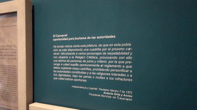 Closeup view of a historical information panel displayed inside a museum gallery, showcasing cultural interpretation and heritage exhibition content in Oaxaca, Mexico