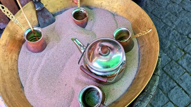Traditional Turkish coffee brewing on hot sand in a cezve in Georgia