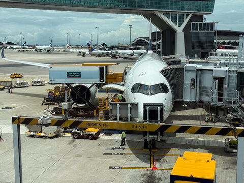 Cathay pacific catering truck preparing airplane for flight