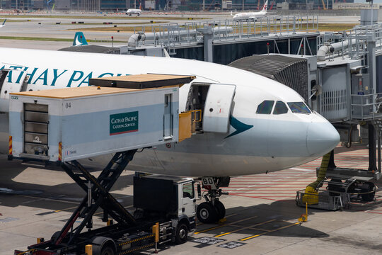 Cathay pacific catering truck preparing airplane for flight