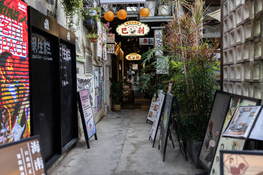 Narrow alley showing restaurants and shops in urban area