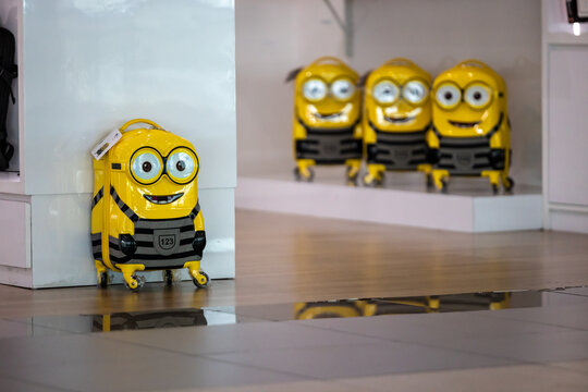 Minion suitcases standing in a store aisle