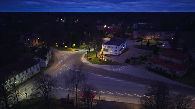 Quiet Baltic crossroads and glowing spruce evoke peaceful winter evening