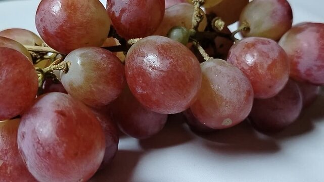 Fresh bunch of grapes isolated on a white background, highlighting the natural texture, vibrant color, and juicy appearance of this nutritious fruit. Perfect for food photography, healthy eating conce