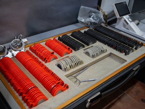 Optometry trial lens set organized in a carrying case at an eye clinic.