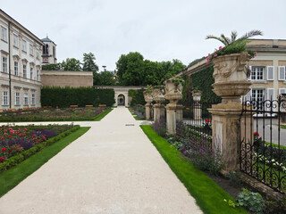 Obraz premium Mirabell Palace and Gardens in Salzburg, Austria on rainy overcast summer afternoon.