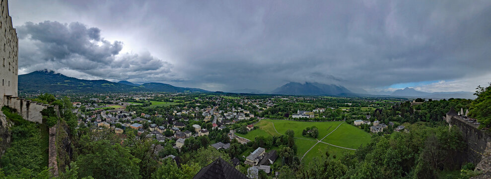Panoramic view of Salzburg, Austria from Hohensalzburg Fortress on hill above city on rainy stormy summer afternoon.