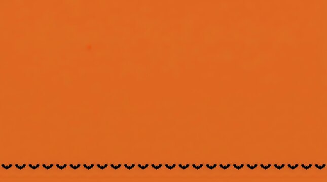 Decorative scalloped border trim in black on vibrant orange background, isolated and ready for design projects, invitations, and craft applications.