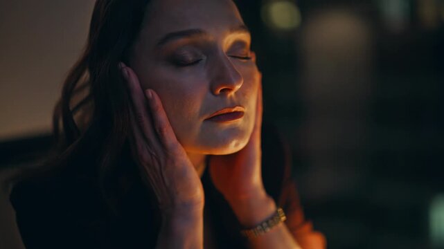 Exhausted employee massaging temples stay late business centre workplace closeup