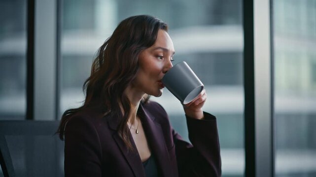 Calm employee drinking coffee in morning office closeup. Business manager rest