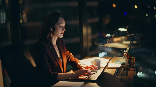 Woman workaholic working late evening on laptop closeup. Manager typing computer