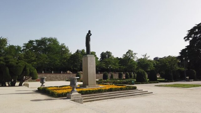 Madrid Spain Slow Pan of Retiro Park Parterre Garden Jacinto Benavente Monument and Yellow Flower Beds