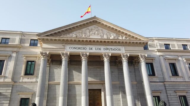 Madrid Spain Low Angle Tilt Up View of Congress of Deputies Portico Architecture and Spanish Flag