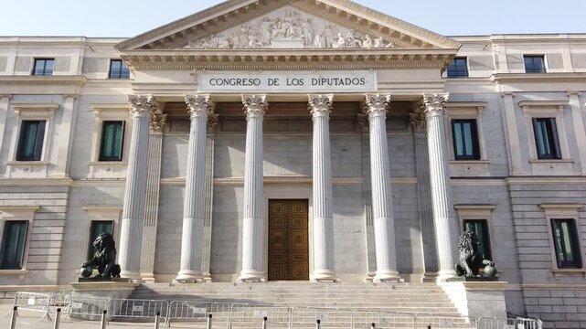 Madrid Spain Low Angle Tilt Up of Congress of Deputies Neoclassical Facade and Spanish Flag