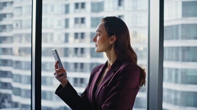 Calm employee looking smartphone at luxury cabinet closeup. Manager reading news