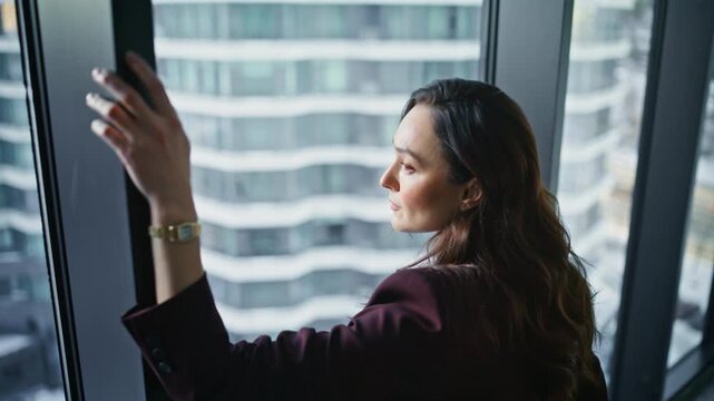 Thoughtful woman contemplating cityscape closeup. Serious pensive boss thinking