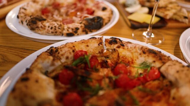 Gourmet Neapolitan Pizza with Prosciutto and Cherry Tomatoes on Restaurant Table