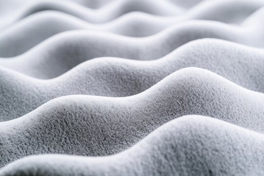 Gray memory foam waves with a textured surface in a macro shot for bedding and ergonomic design marketing