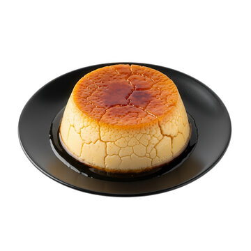Golden brown flan dessert on black plate