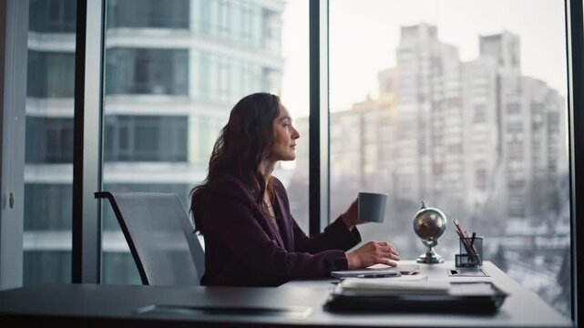 Relaxed businesswoman enjoy coffee break sitting modern office desk closeup