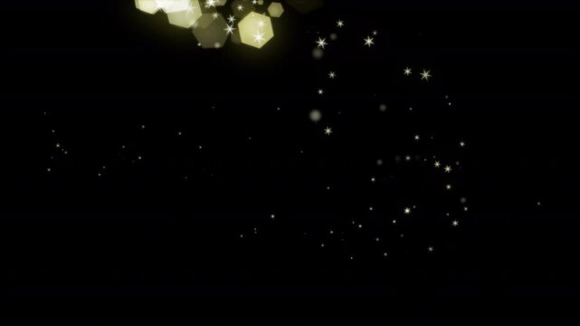 Golden bokeh particles shimmer brilliantly against a deep dark starry night sky.