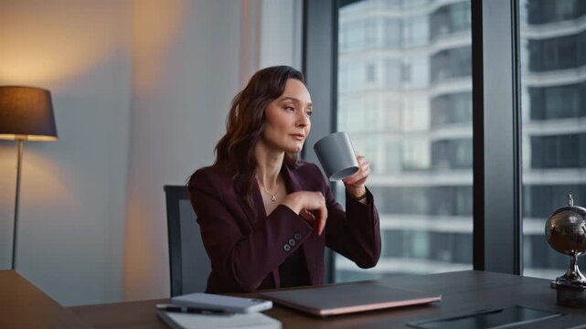 Entrepreneur taking coffee break sitting office desk before laptop work closeup