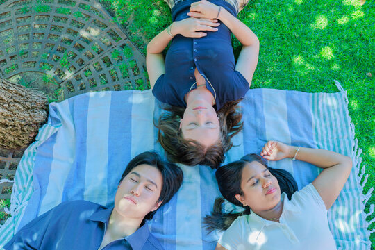 International University Students Lying on Grass in a Circle