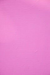 Fototapeta premium Bright pink wall with smooth texture in simple setting