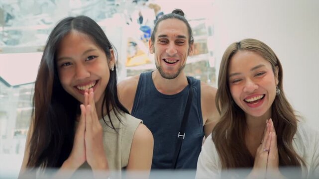 group of people expressing emotions and gestures in a happy and playful indoor setting, possibly a room with light-colored walls, frontal view, slightly elevated angle.