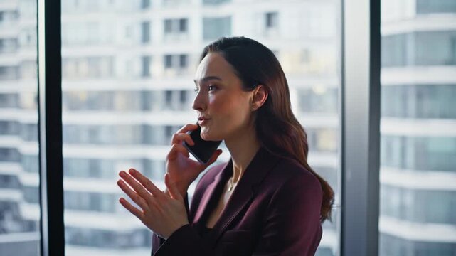 Positive female director calling at business hall closeup. Happy businesswoman