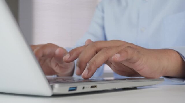 Close-up Hands Typing on Laptop Keyboard While Working at Modern Office Desk, Professional Using Notebook Computer for Business, Remote Work, Online Communication, Productivity and Digital Technology