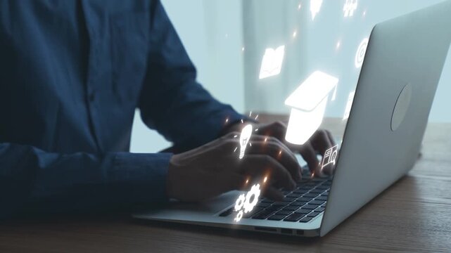 Young professional working on laptop with digital education icons floating around, representing modern learning and technology integration in studies. Qubit.