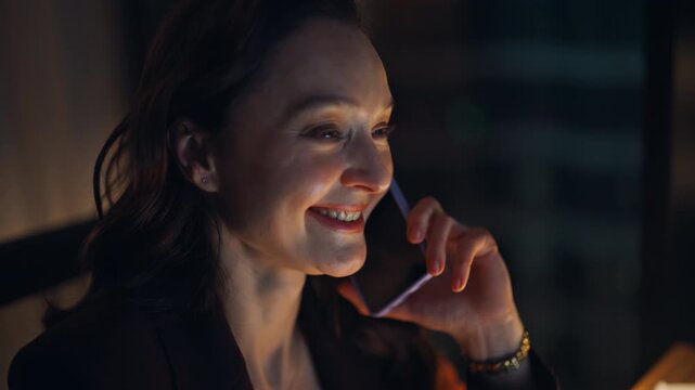 Smiling entrepreneur talking cellphone at night closeup. Executive discussing