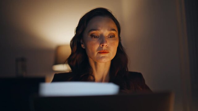 Fatigued director working late looking laptop rubbing face late evening closeup