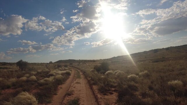 POV hyperlapse of a 4x4 vehicle driving through the Kalahari desert, crossing dunes.