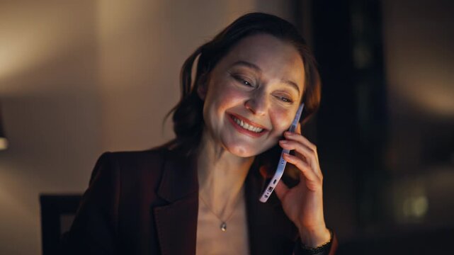 Writing entrepreneur calling cellphone talking at night office space closeup