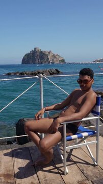 Male tourist enjoying a sunny Mediterranean vacation on Ischia island, Italy