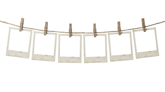 Empty polaroid photo frames hanging on a rope isolated on transparent background