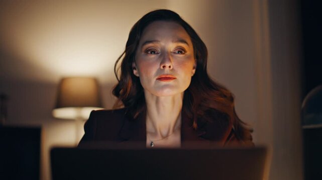 Late manager work routine sitting evening office with laptop indoors closeup