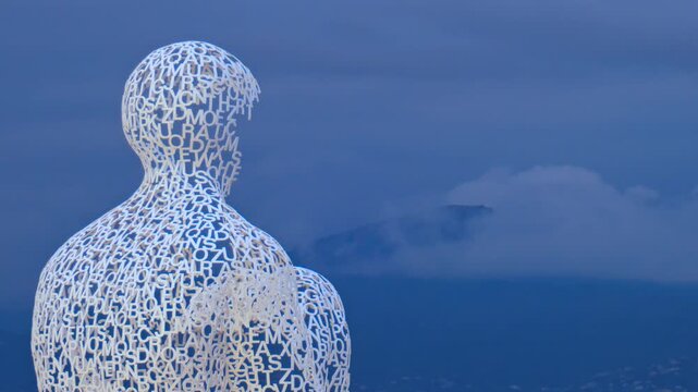 sculpture with human form made of letters, words on human sculpture, art in nice.