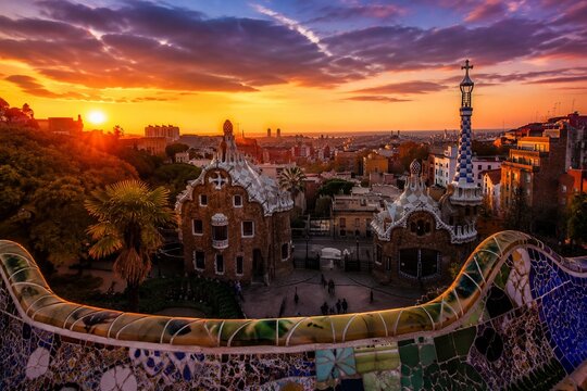 Barcelona park panorama at sunset with mosaic benches and city skyline