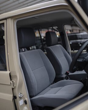 Car interior with front seats dashboard and steering wheel view.